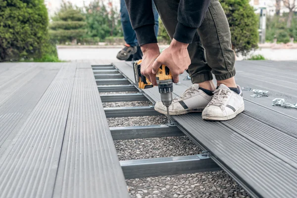 Ground-level composite deck without railing in Newton MA backyard