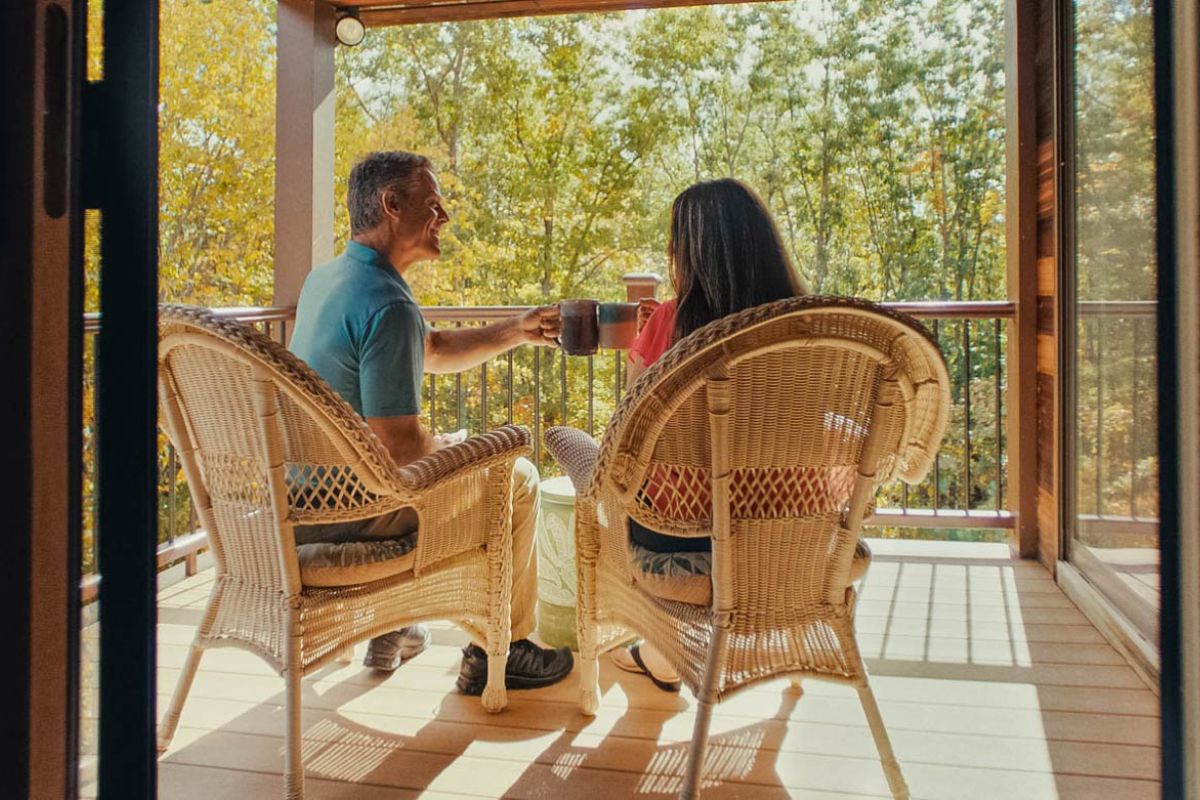 couple drinking cofffee on the deck of the house