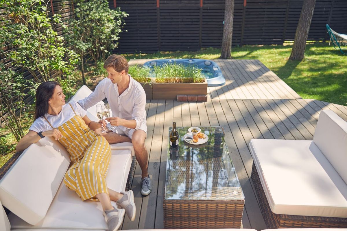 couple drinking wine on the deck of the house