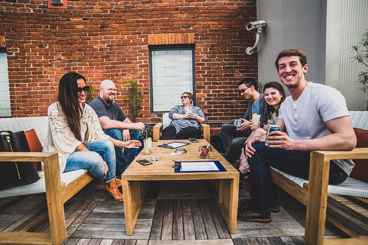 family and friends catching up together sitting on the deck of house