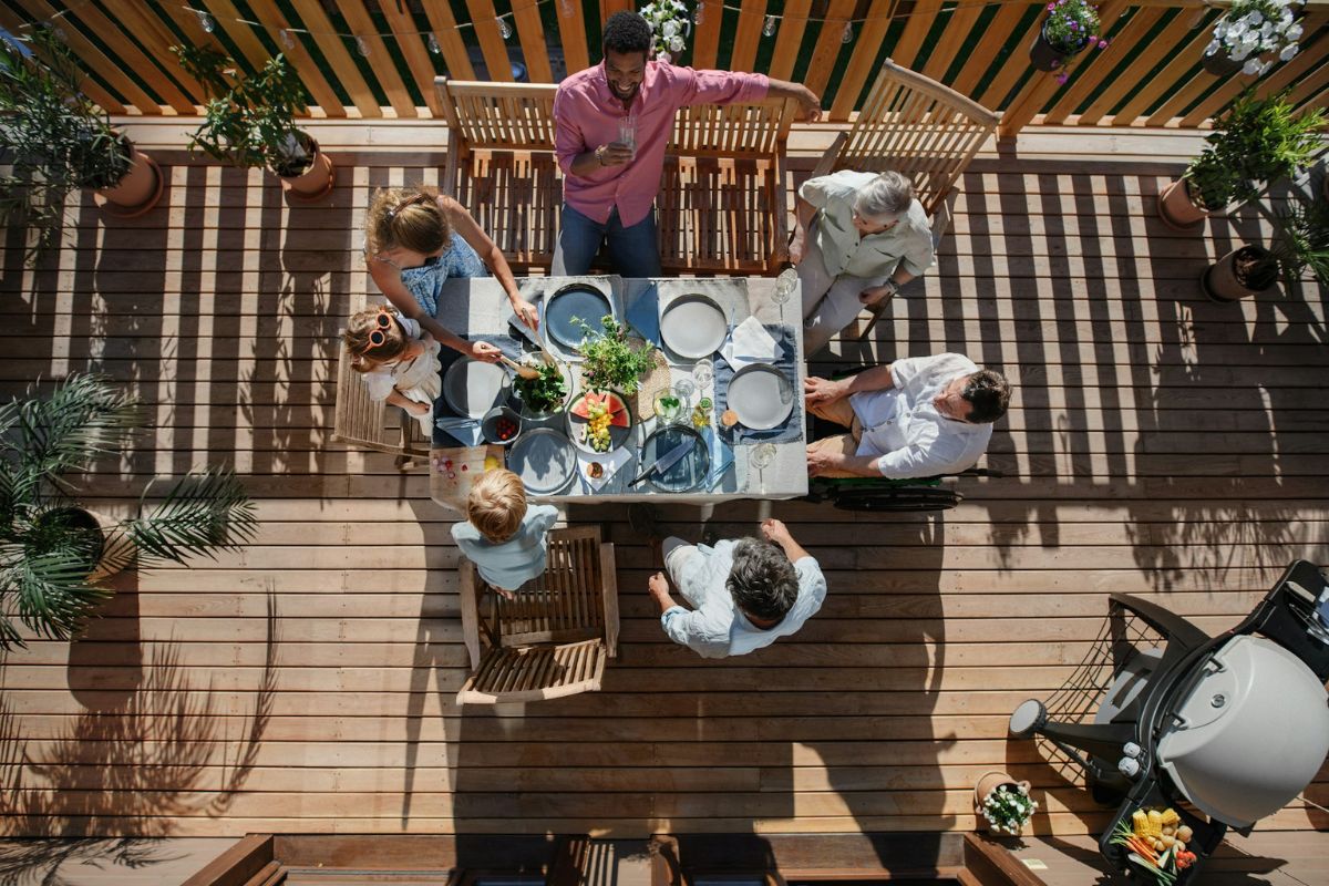 family and friends having lunch on outdoor deck of the house