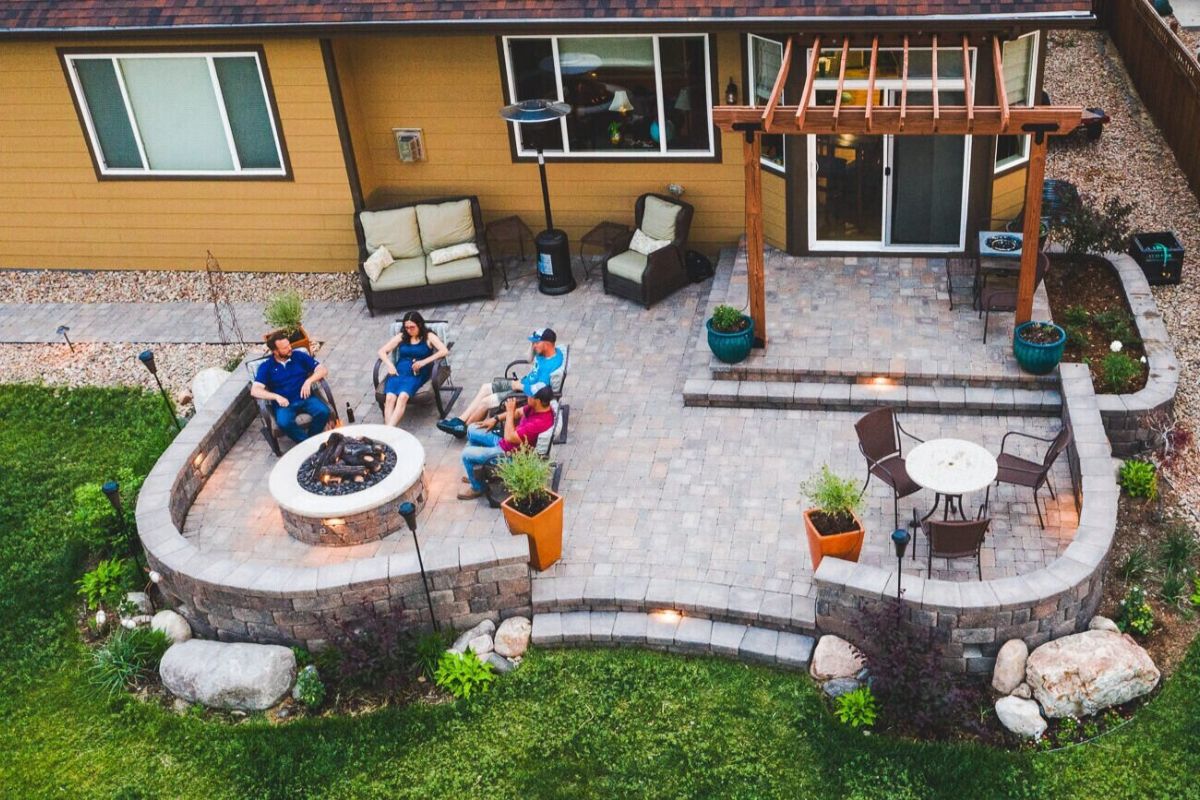 group of friends drinking beer in hardscape patio