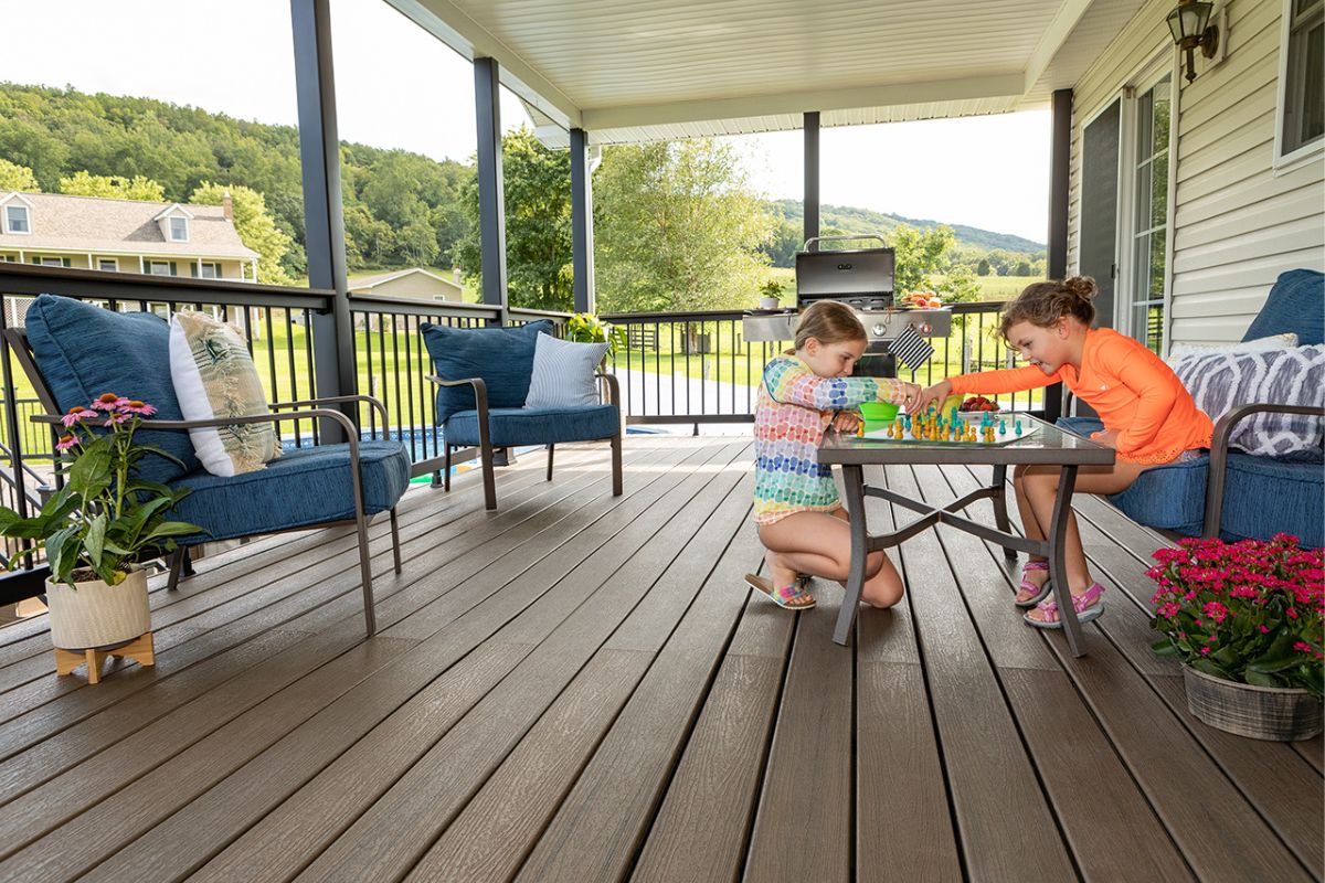 two sisters playing chess on the deck of the house