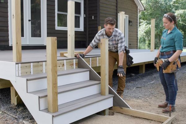 Man and women building corner deck stair